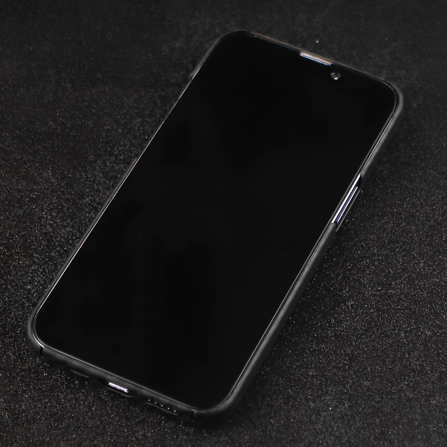 Matte black Kevlar fibre iPhone 12 case with crater texture and exposed buttons for drop protection