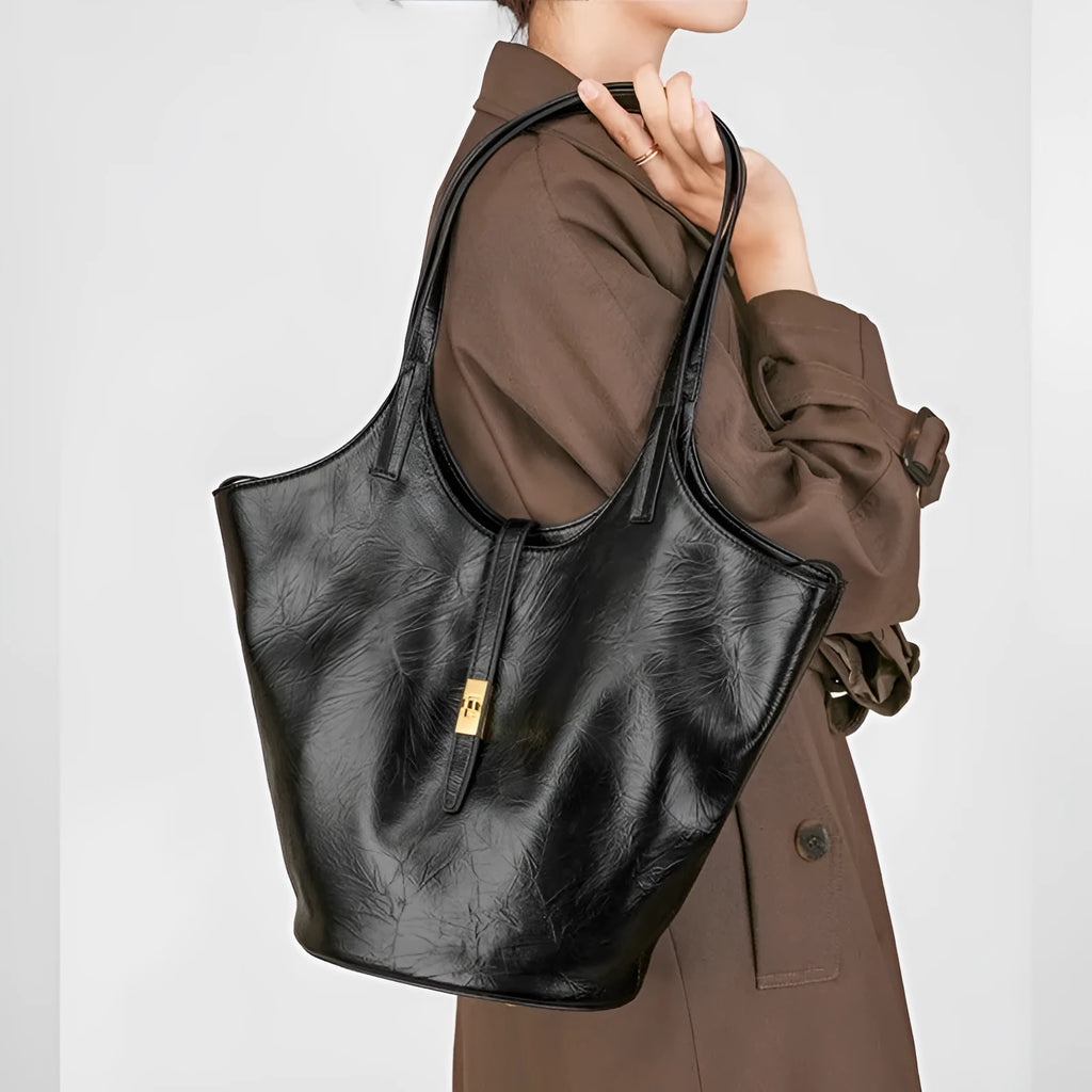 Black genuine leather bucket bag with sewing thread detail and single shoulder strap