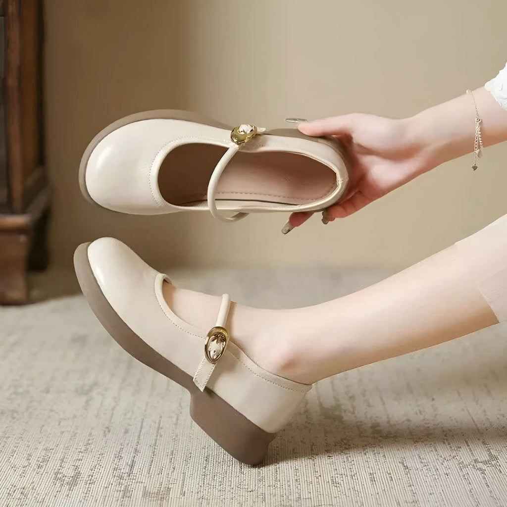 Flat black cheongsam leather shoes with a white skull pattern on the toe and a light brown wedge heel.