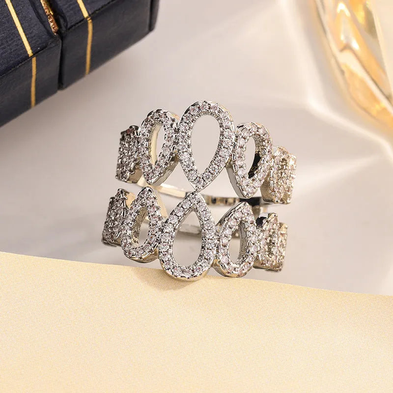Women's gold plated copper ring with inlaid zircon stone and hexagon design on white background