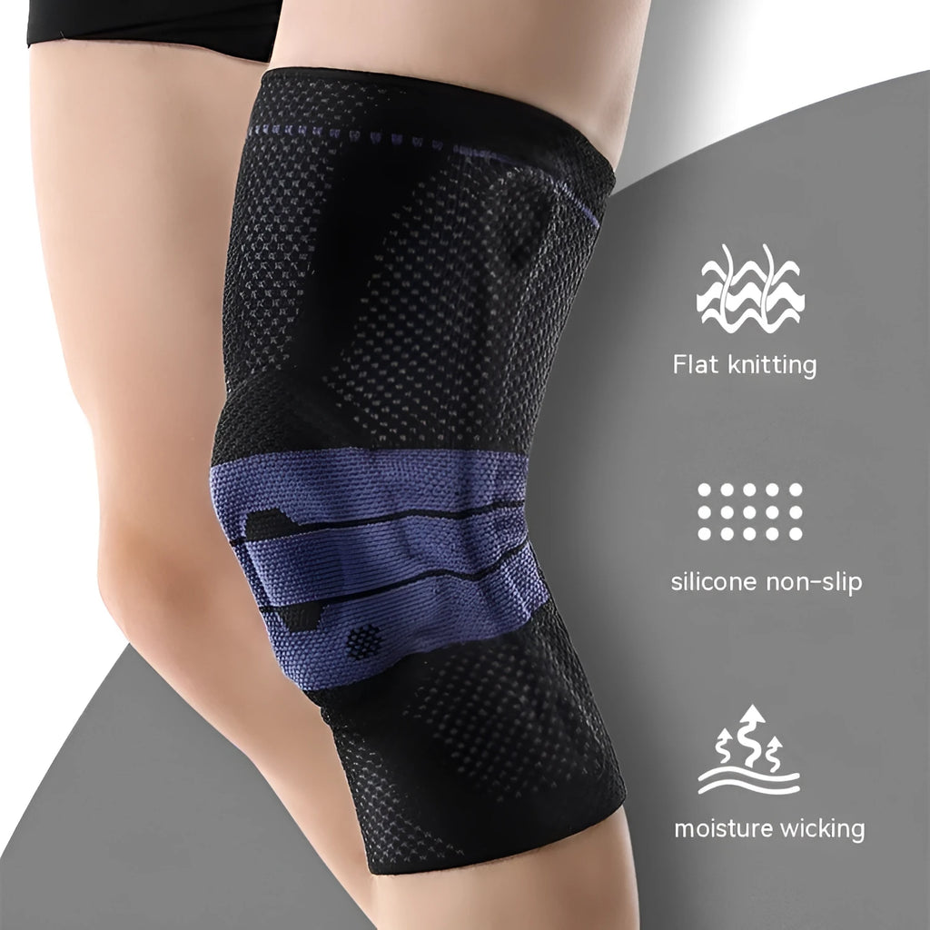 A pair of adult sports knee pads in a black and blue colourway, shown on a knee for scale.