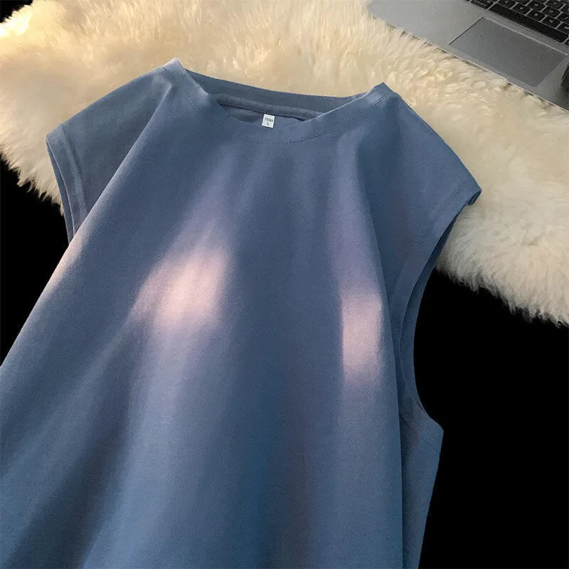 Men's loose solid colour cotton tank top t-shirt on a hanger, showing straight hem and sleeveless design.
