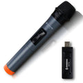 Black dynamic microphone with metal grill, USB receiver, adapter, and audio cable on dark background