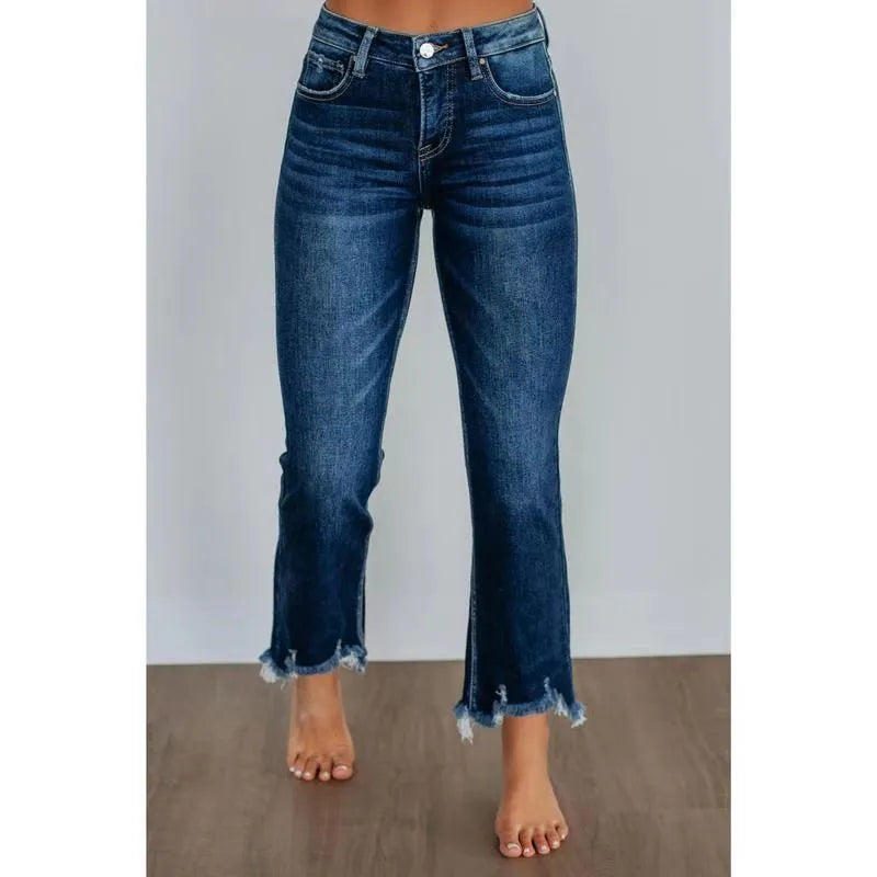 Women's solid colour denim jeans with a hand-worn distressed finish in dark blue.