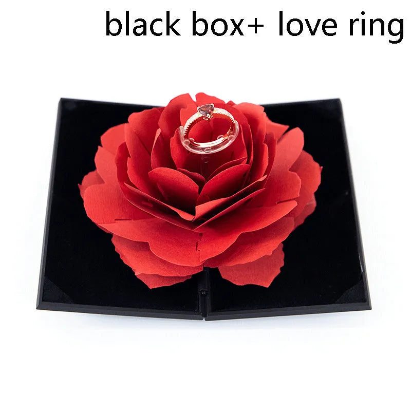 Red 3D heart-shaped rotating ring box with a rose flower decoration, open to show ring placement.