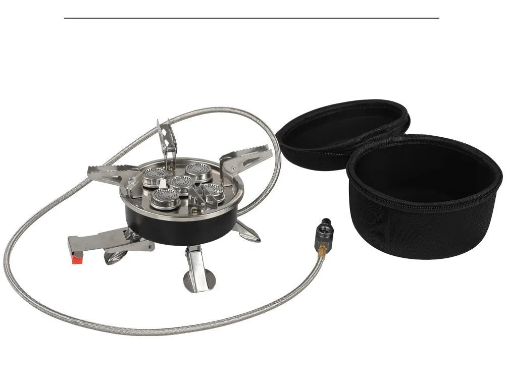 Silver portable split stove for outdoor camping and picnics on a flat surface.