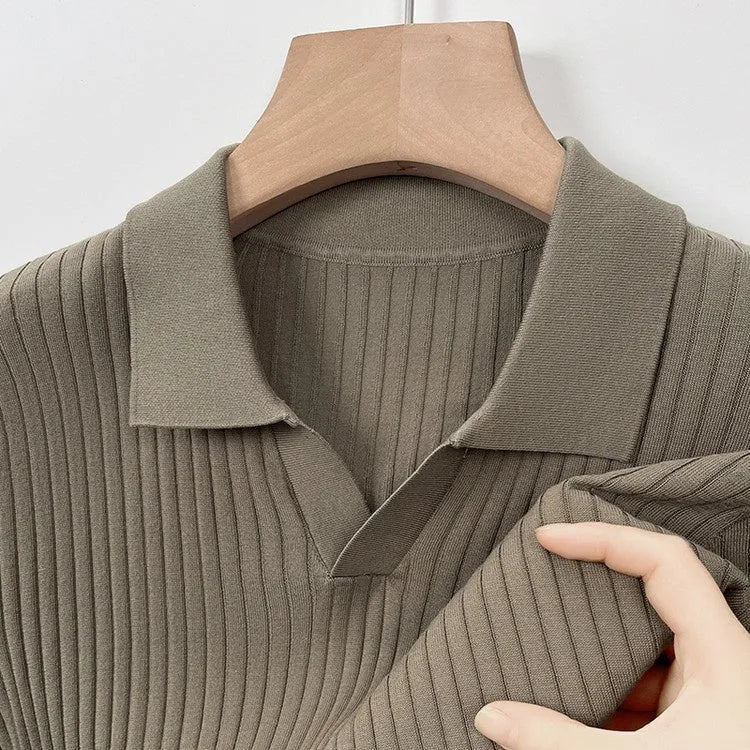 Man wearing a striped mulberry silk lapel T-shirt in grey, showing short sleeves and a straight fit.