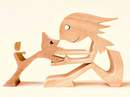 Handcrafted wooden dog sculpture featuring a man and his loyal canine companion