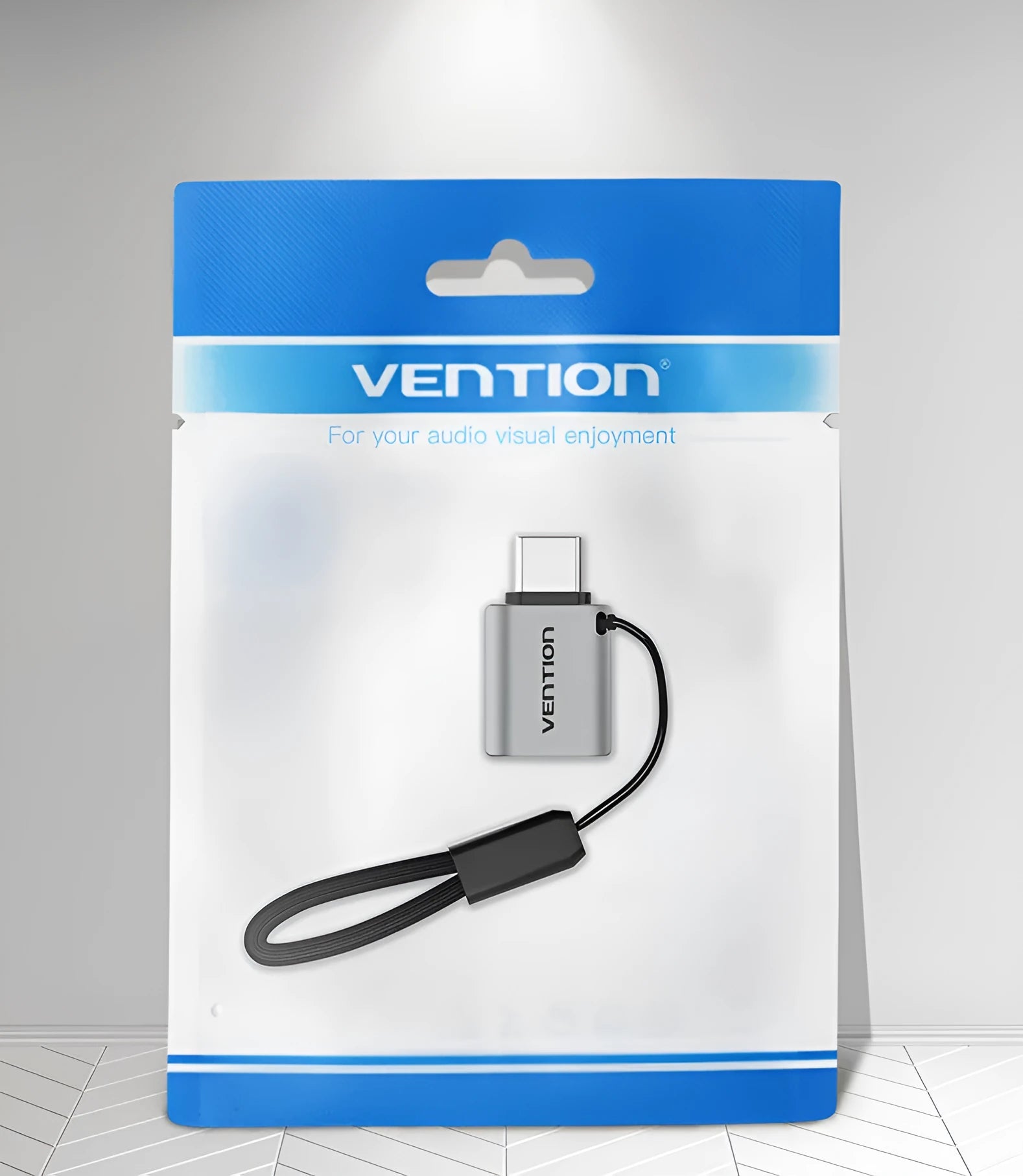 Grey aluminium alloy USB-C male to USB-A female OTG adapter with a black lanyard attached.