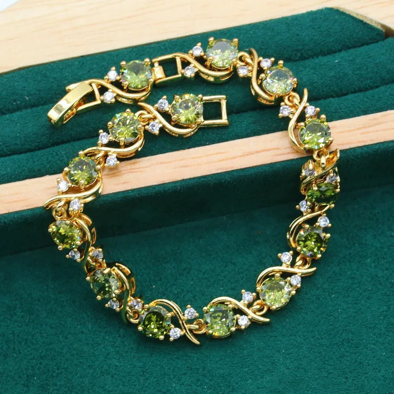 Olive green zircon jewellery suit for women featuring a snake bones chain necklace, matching earrings, and ring with a crown pattern.