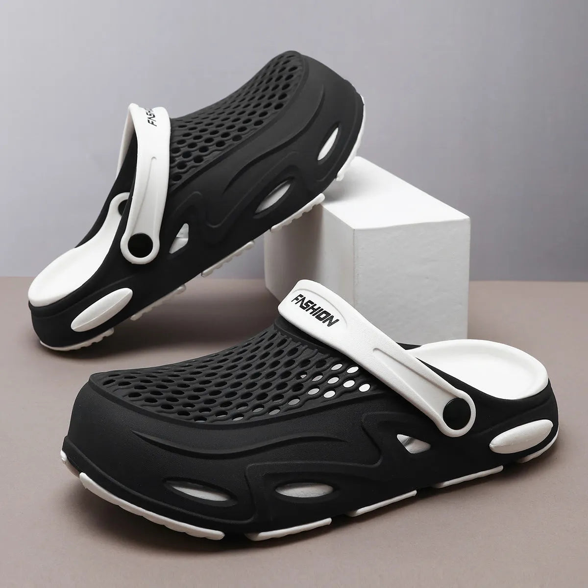 Men's grey closed toe EVA beach slippers with a non-slip sole and flat heel on a poolside.