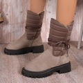 Black women's chunky heel snow boots with lace-up design and suede upper on a rubber sole