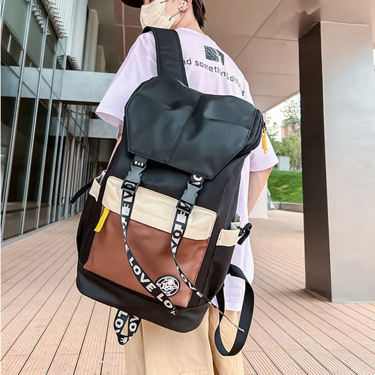 Black oxford cloth backpack with adjustable straps, shown next to green and red colour options.
