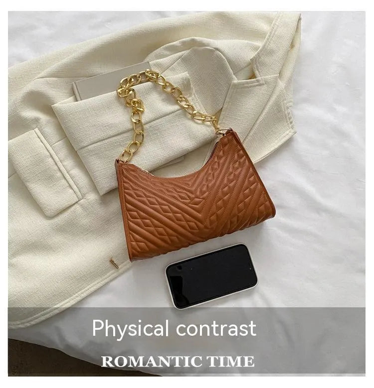 Brown pleated chain strap baguette shoulder bag showing vertical square shape and soft handle.