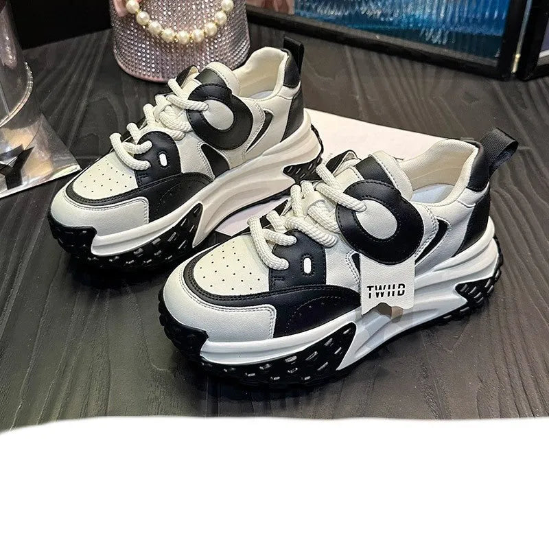 A pair of thick-soled leather casual shoes with a wedge heel and front lace-up, shown in one of the available colours.