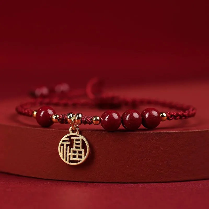 Cinnabar Ashore braided rope good luck bracelet with a blessing card charm.