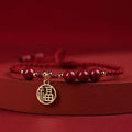 Cinnabar Ashore braided rope good luck bracelet with a blessing card charm.