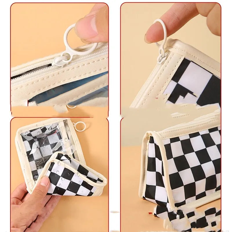 Transparent PVC pencil case showing internal chessboard grid pattern, measuring 21.5cm long.