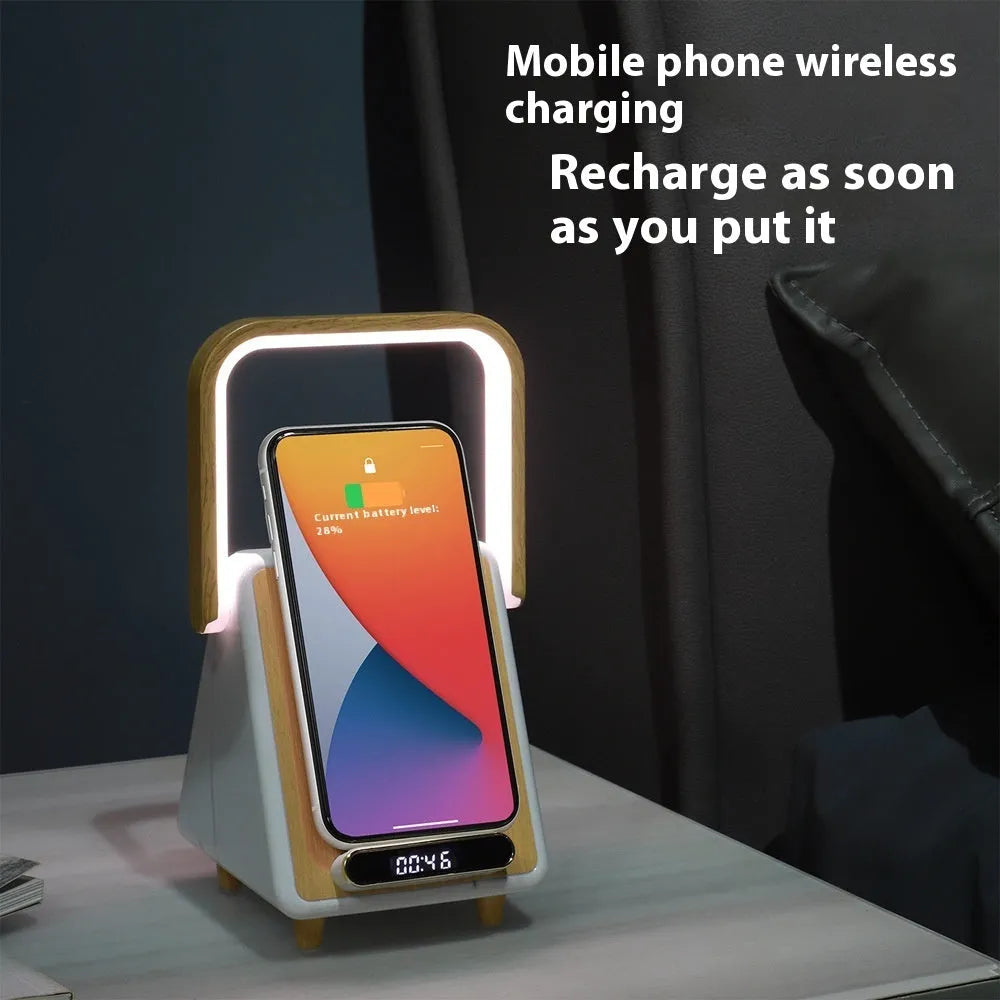 Wireless charging induction Bluetooth speaker small night lamp in Platinum Jazz finish with USB cable on a wooden desk