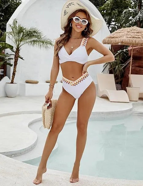 Black and white lace-up women's bikini swimsuit with high-waist briefs laid flat.