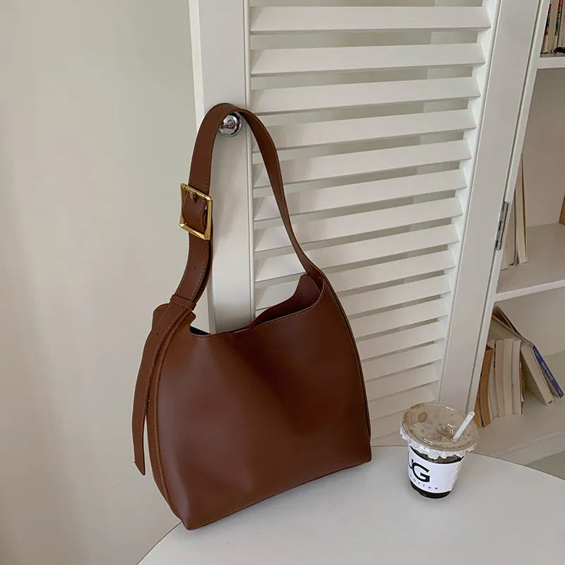 Women's solid colour PU leather shoulder bag in black, square vertical shape with sewing thread detail and single strap