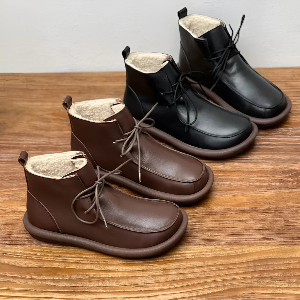 Women's black cowhide leather ankle boots with flat heel and round toe