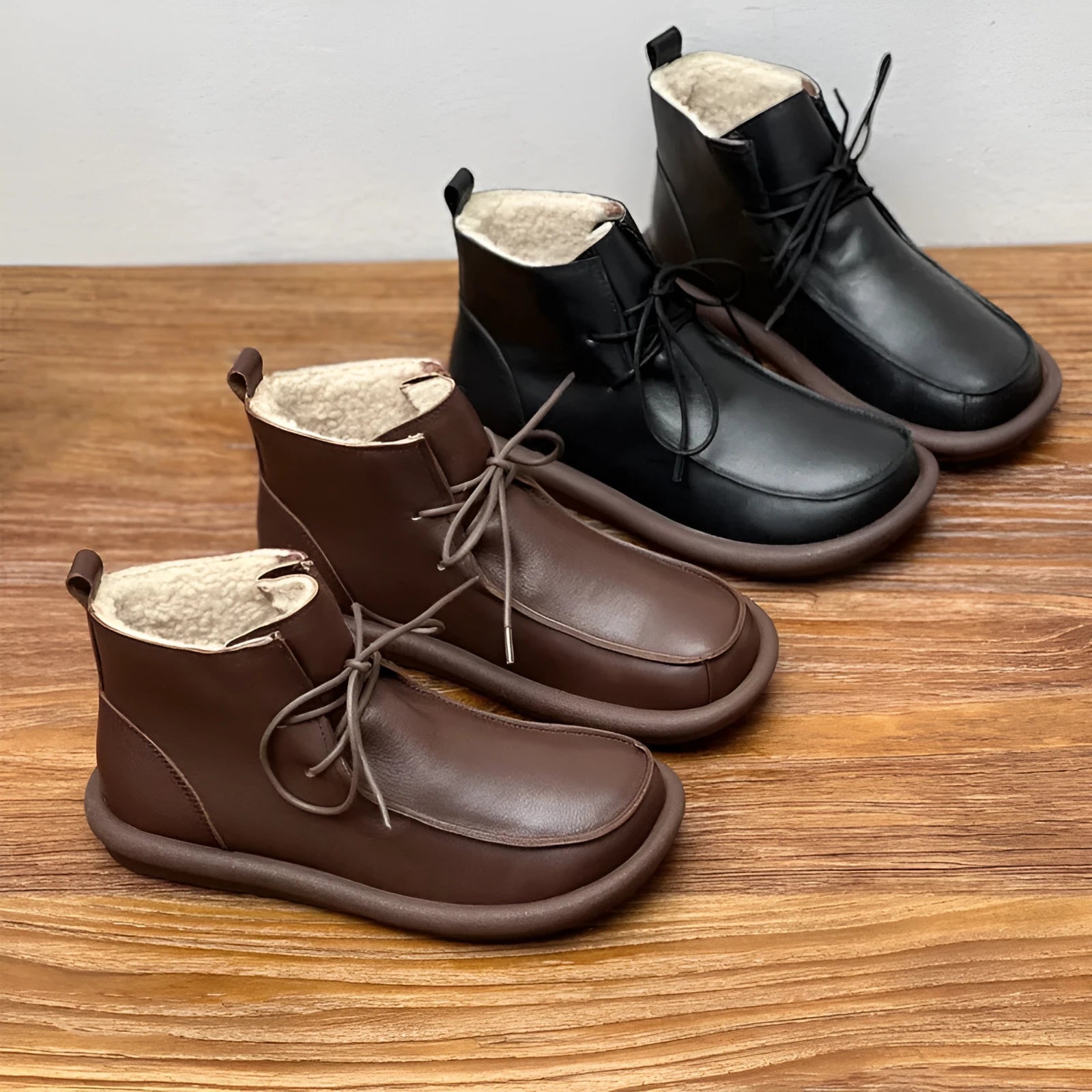 Women's black cowhide leather ankle boots with flat heel and round toe
