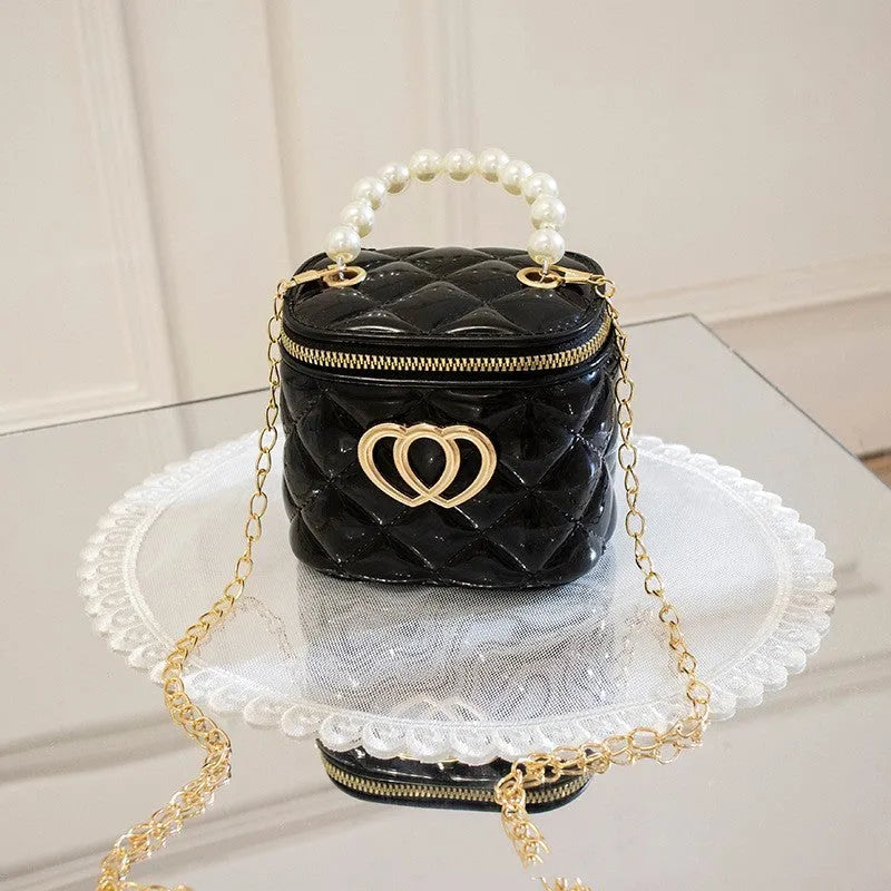 Women's PVC bucket gel handbag in apricot colour, showing heart-shaped pattern on lining.