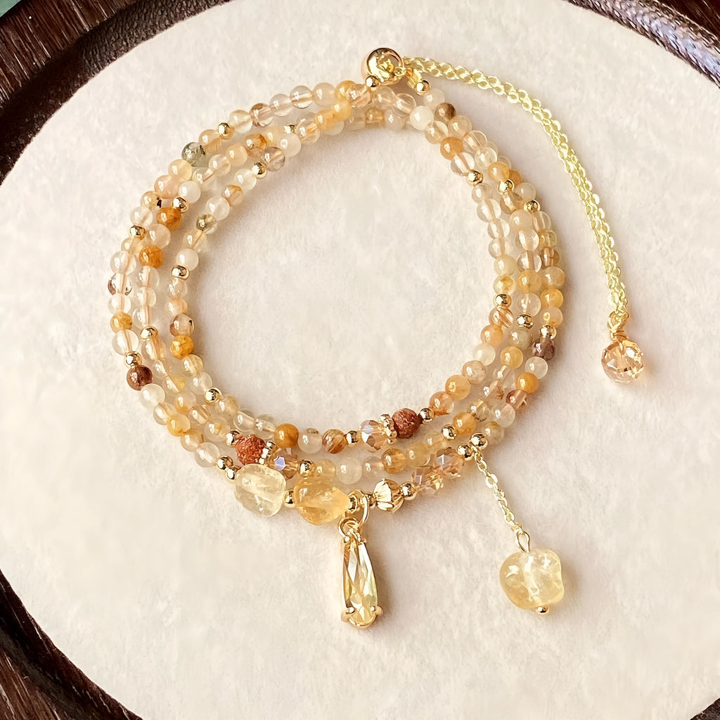 Women's natural citrine bracelet with three interconnected circles in caramel gold colour featuring Saturn design elements