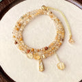 Women's natural citrine bracelet with three interconnected circles in caramel gold colour featuring Saturn design elements
