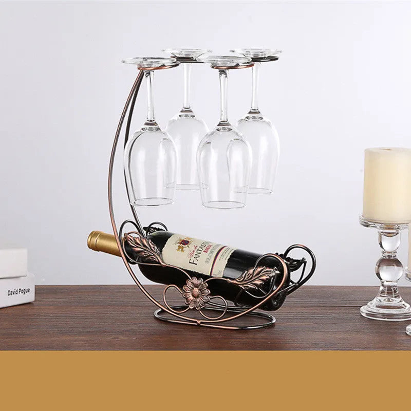 Iron wire goblet shelf holding four wine glasses in bronze finish on a wooden cabinet
