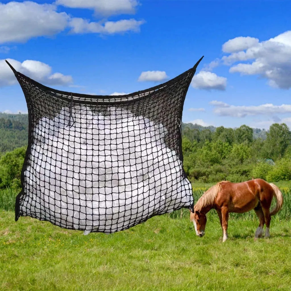 Black woven grid horse feeding bag hanging on a fence
