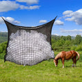 Black woven grid horse feeding bag hanging on a fence