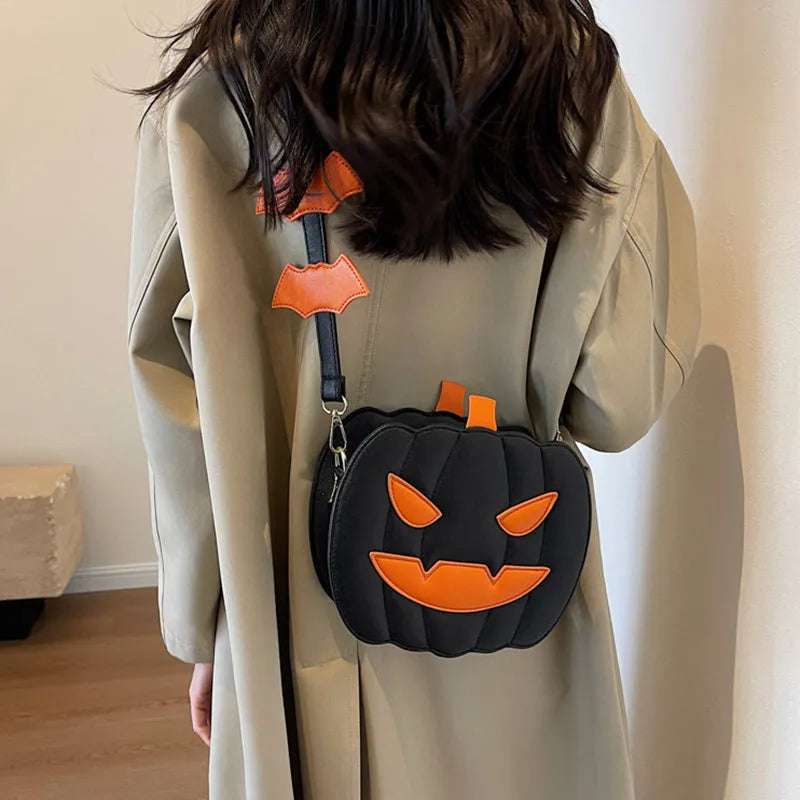 Horizontal view of a PU crossbody bag with pumpkin and bat cartoon design in orange colour option.