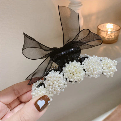 Korean pearl bow hair clip in black with alloy construction and manual bowknot design