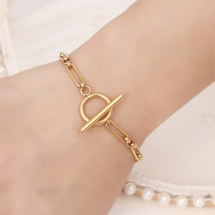 Stainless steel Chopin chain necklace and bracelet set in gold finish on white background