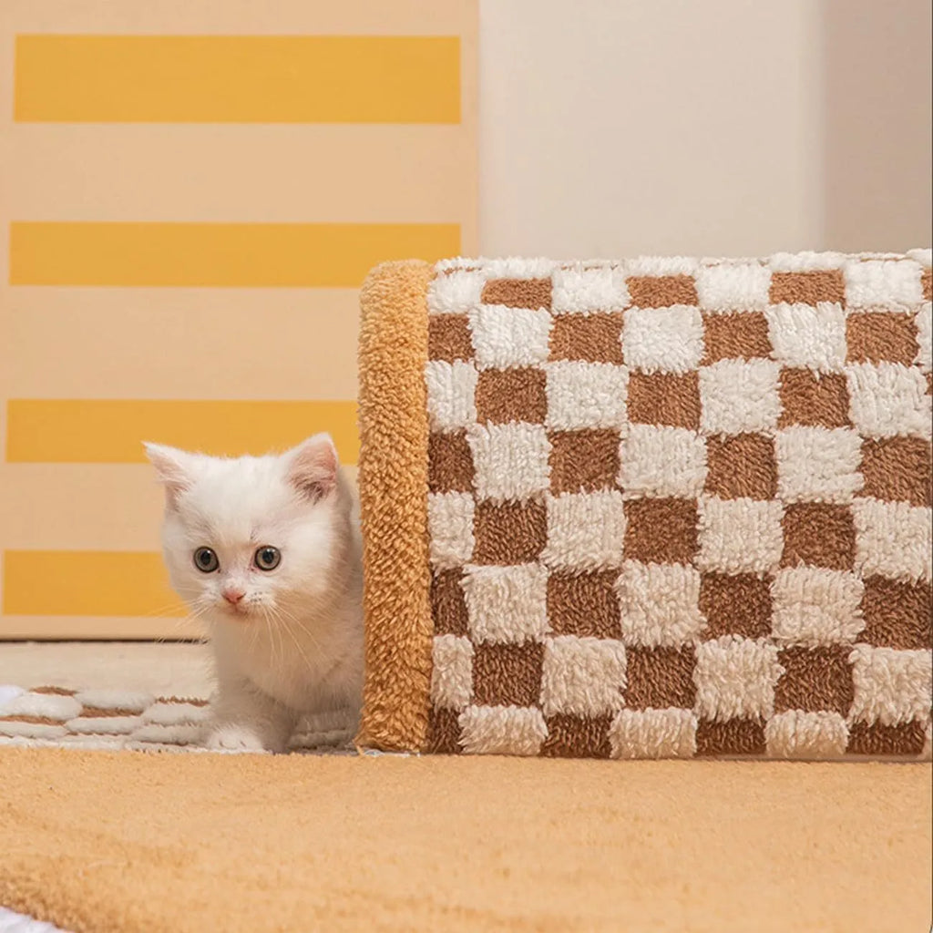 Large plush fan-shaped dog and cat bed with central tunnel, in coffee colour, on a floor.