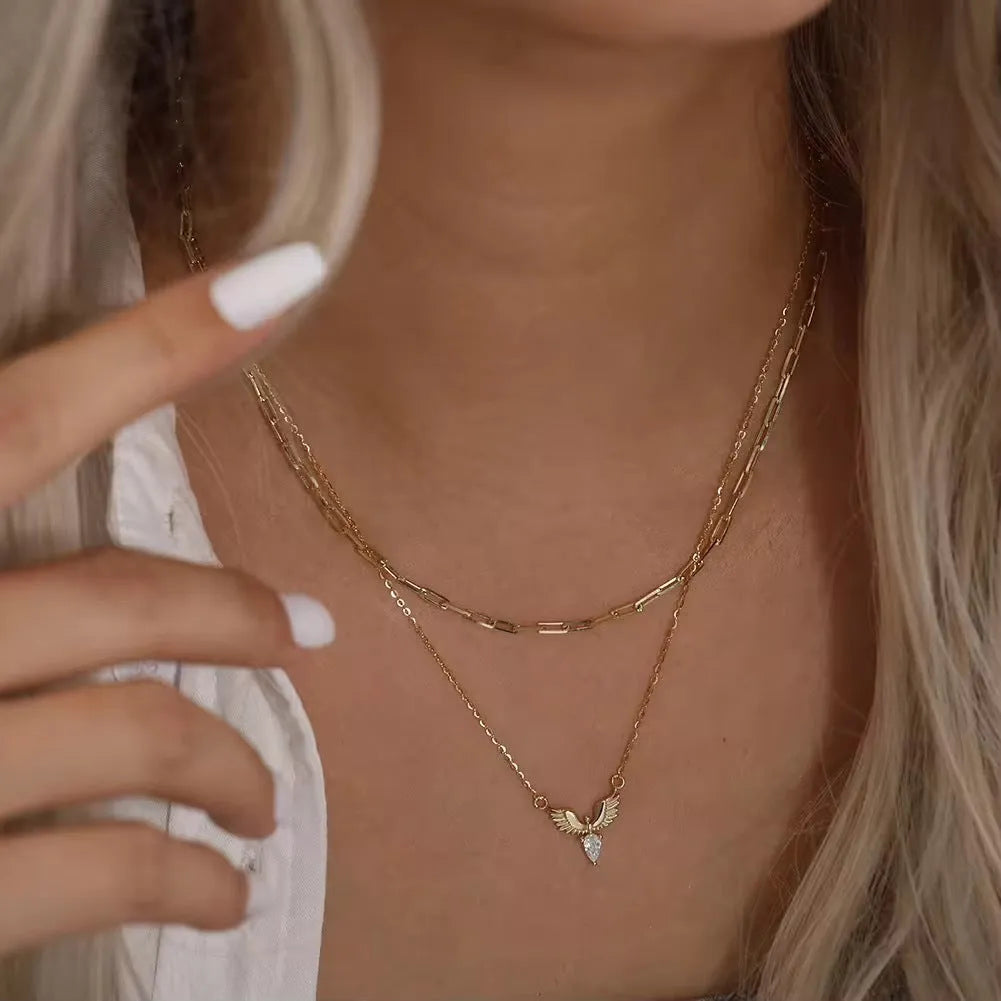 Eagle pendant necklace on an adjustable O-ring chain, available in white gold or yellow gold electroplate.