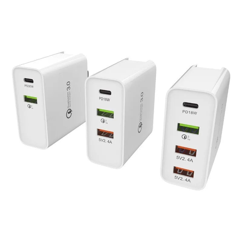 White USB fast wall charger with multiple ports and international plug adapters.