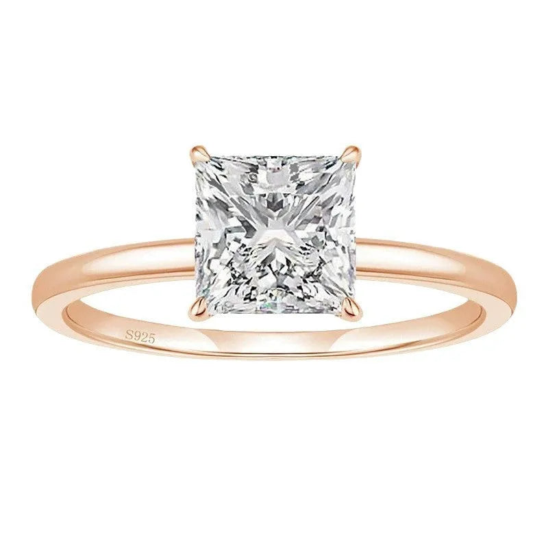 A polished geometric sterling silver ring for women on a grey background.