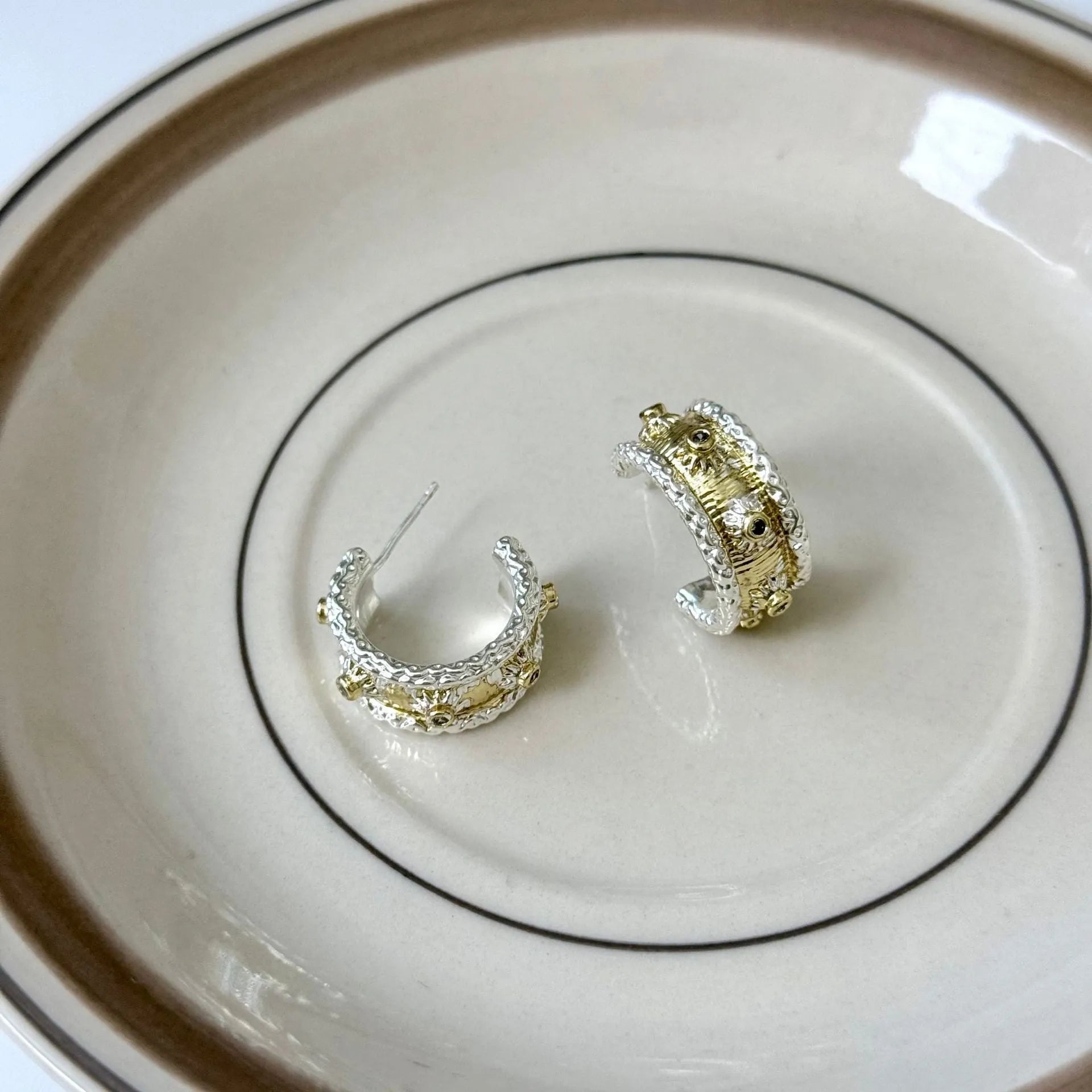 Gold and silver colour matching C-shaped brushed ring earrings with 925 silver needle on display
