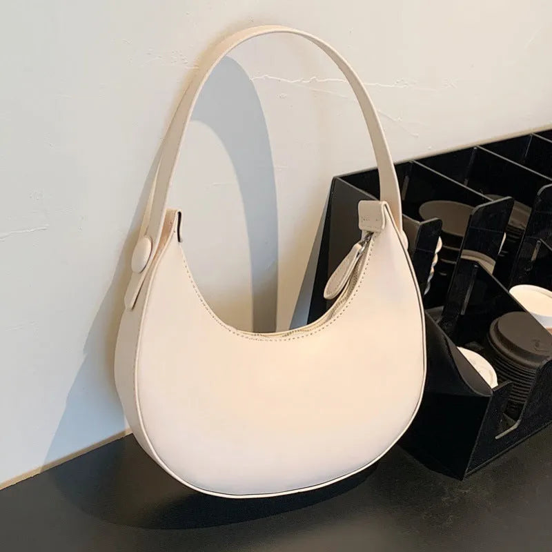 Retro dumpling-shaped women's shoulder bag in PU leather, shown in a choice of four colours.