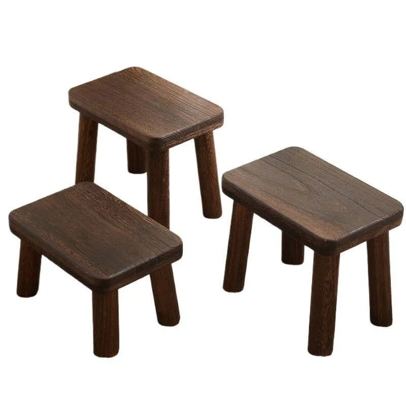 Solid wood household shoe changing stool with a distressed finish and bracket structure legs.