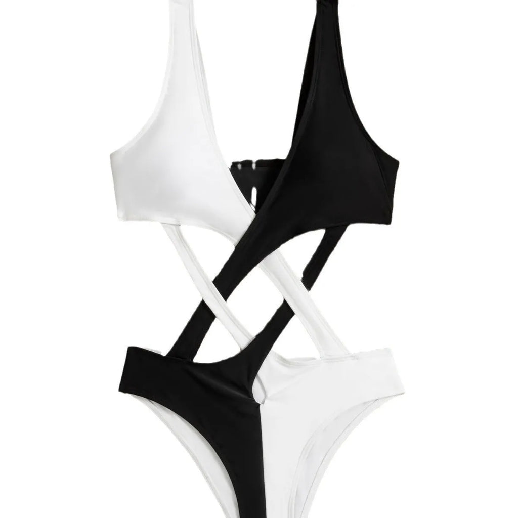 White women's one-piece swimsuit with colour-block and hollow-out design on a mannequin.