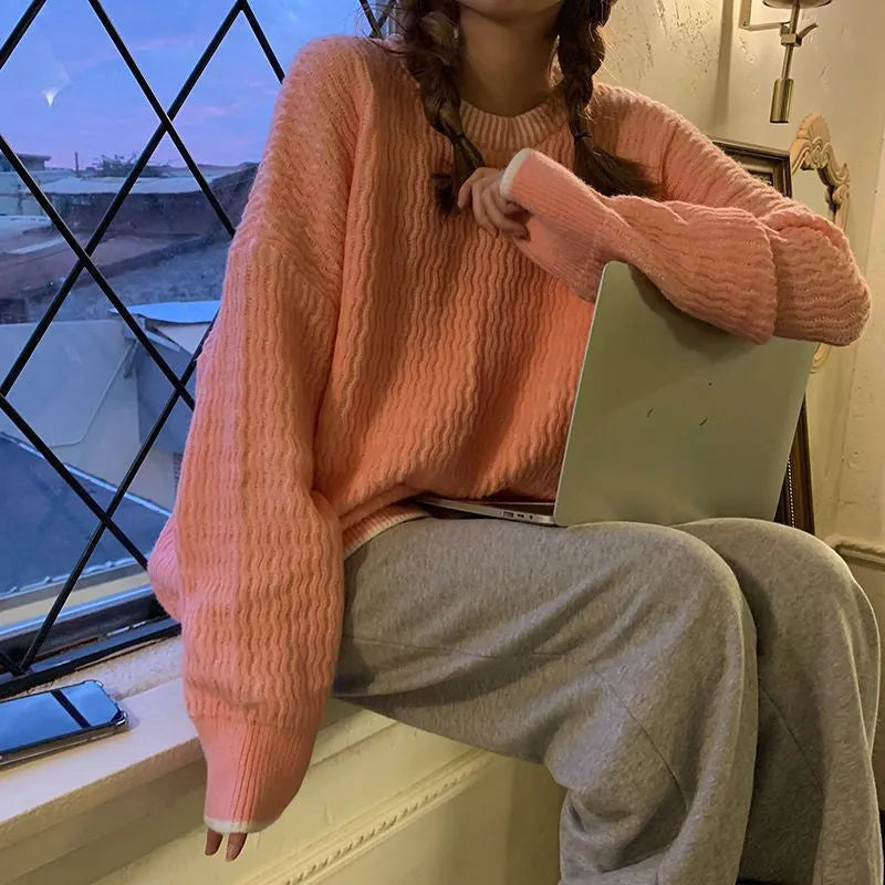 A woman's loose-fit pullover sweater in a solid lake blue colour with a retro style and regular sleeves.