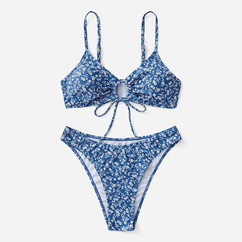 Blue women's swimsuit three-piece set showing separate top and shorts on a neutral background.