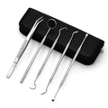 Stainless steel dental tools set with oral mirror and probes on grey background
