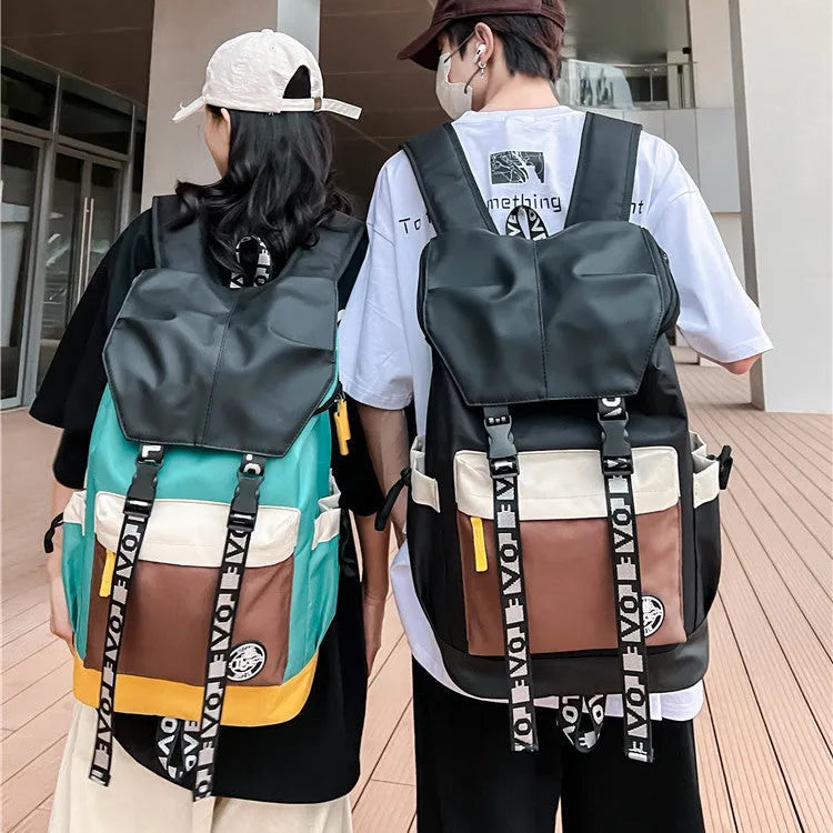 Black oxford cloth backpack with adjustable straps, shown next to green and red colour options.