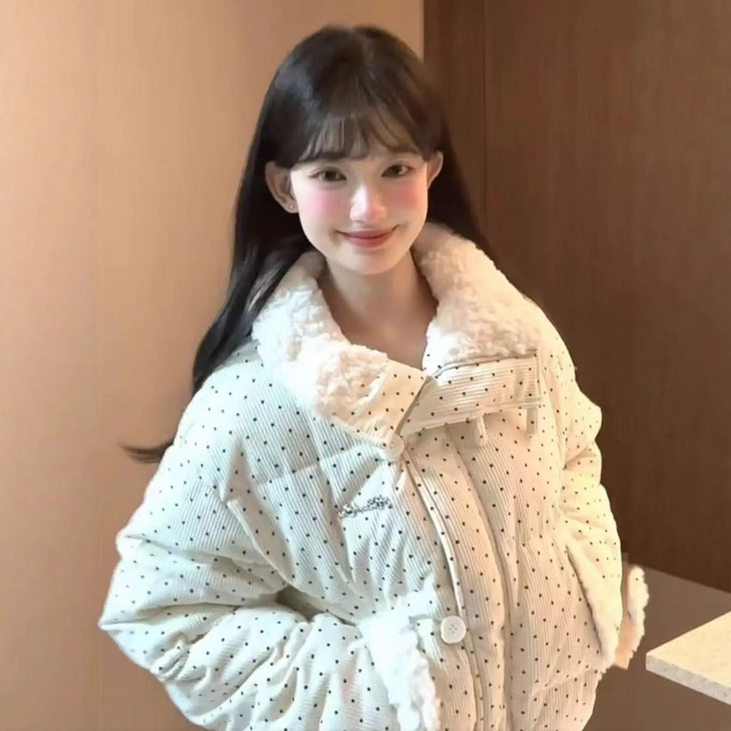 Beige cotton-padded coat with fur collar, dot pattern, and front pockets on a model