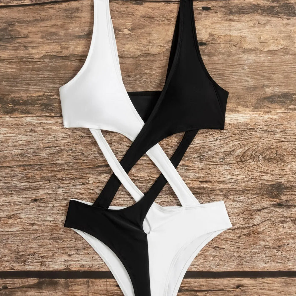 White women's one-piece swimsuit with colour-block and hollow-out design on a mannequin.